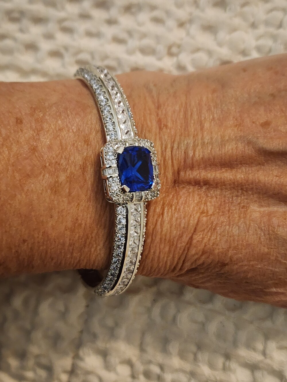 Silver-Tone Rhinestone Bracelet with Deep Blue Center Stone Hinged Oval Bangle